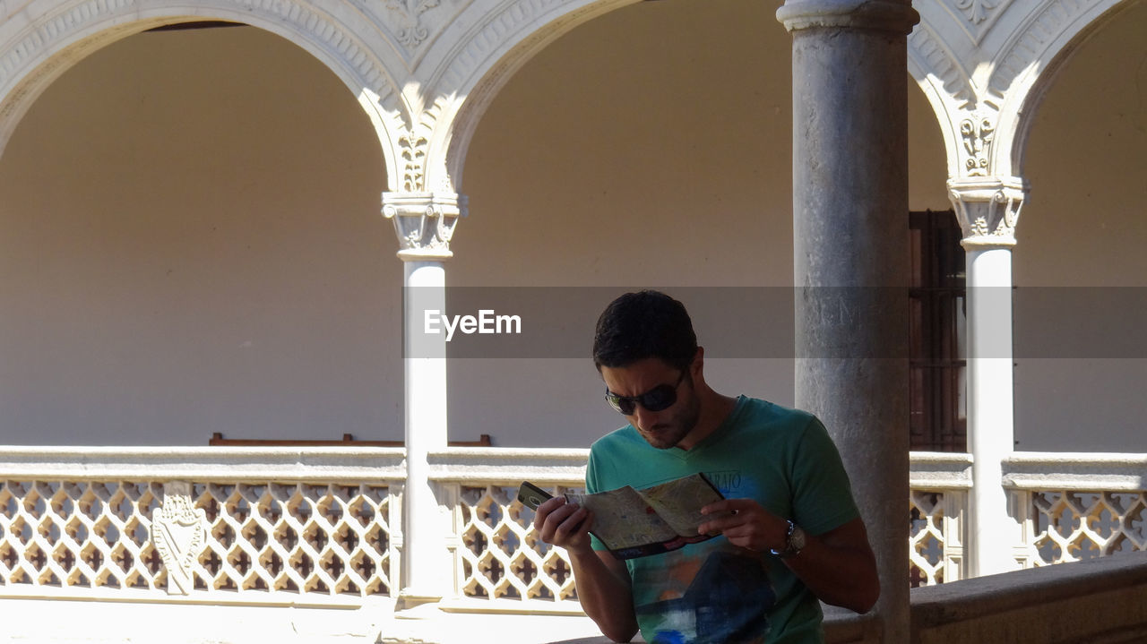 YOUNG MAN LOOKING AT BUILDING