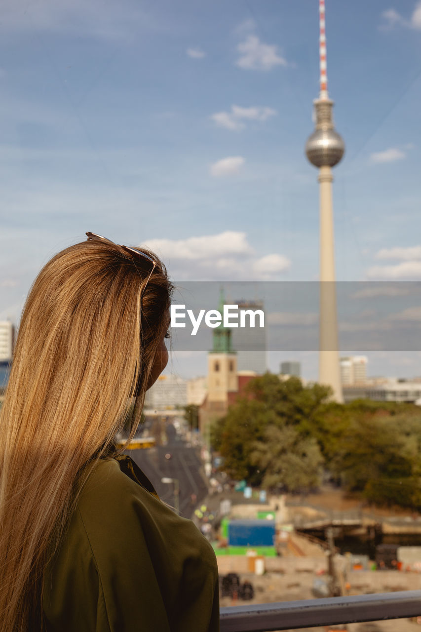 Woman looking at fernsehturm in city