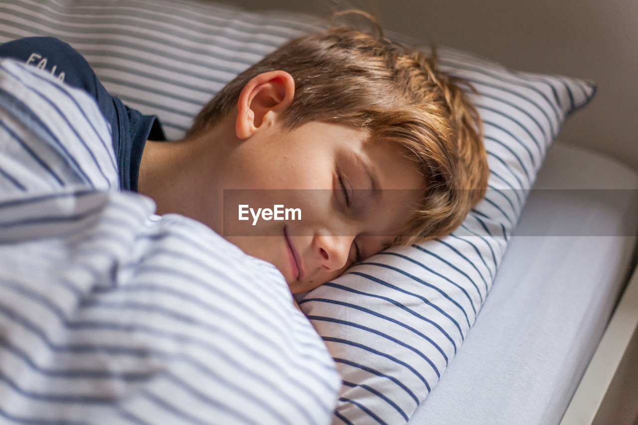 Portrait of boy sleeping in bed