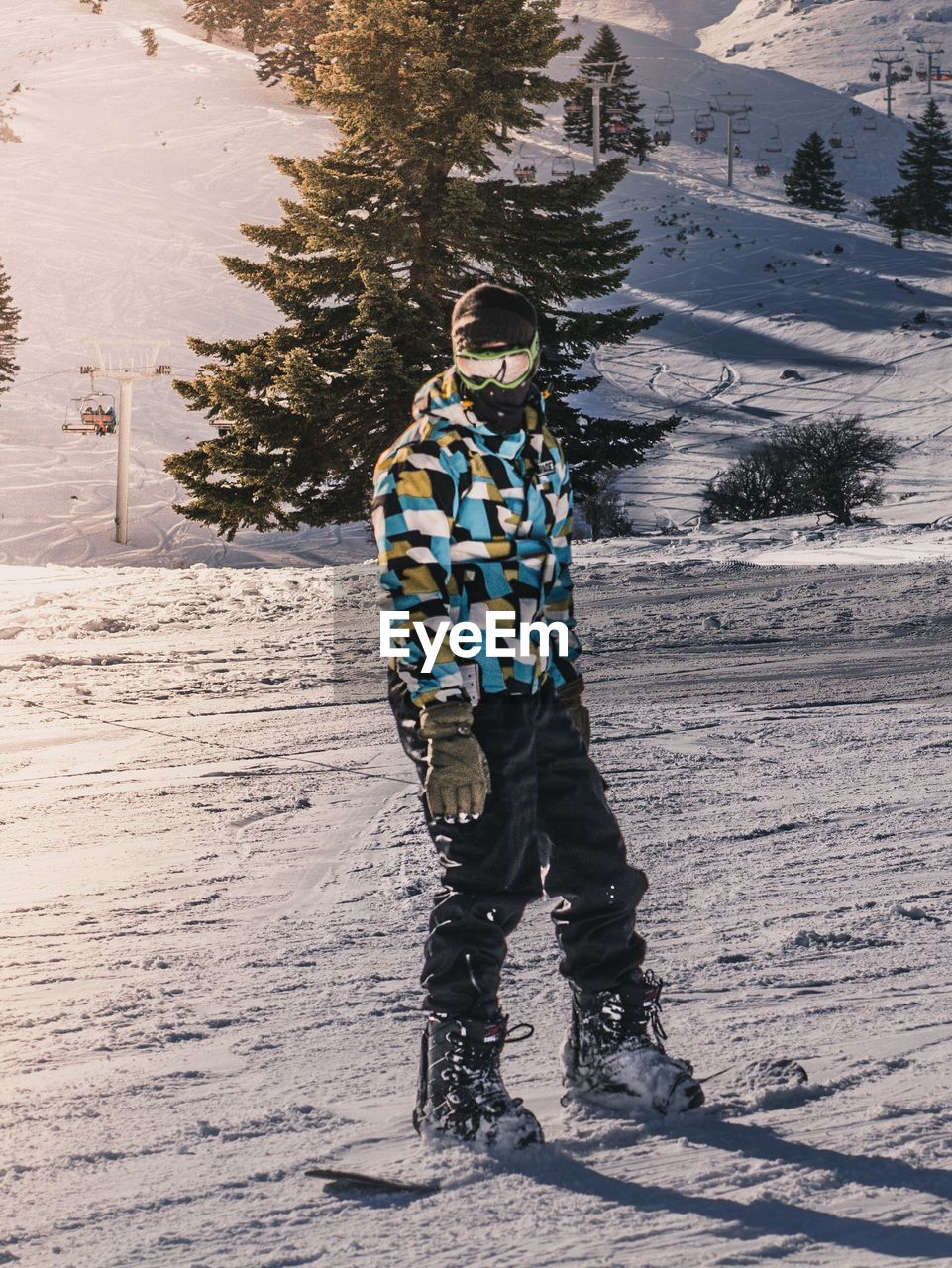 WOMAN STANDING ON SNOW COVERED LAND