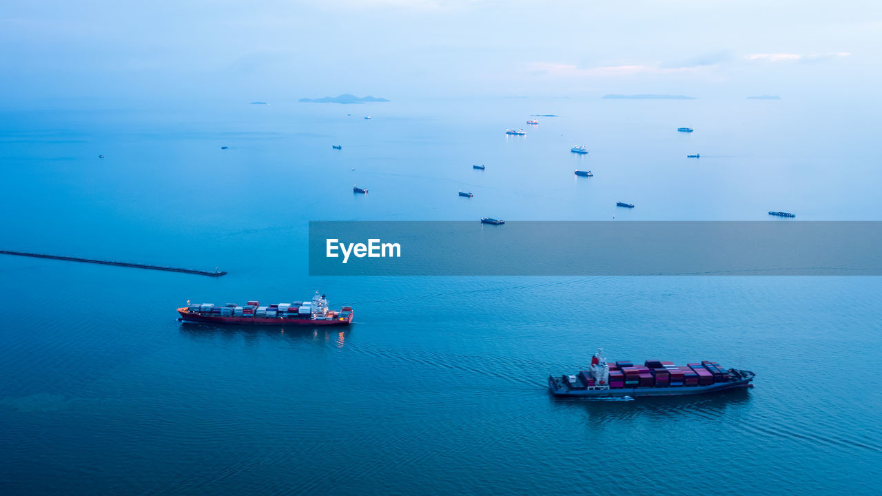 Boats in sea against sky