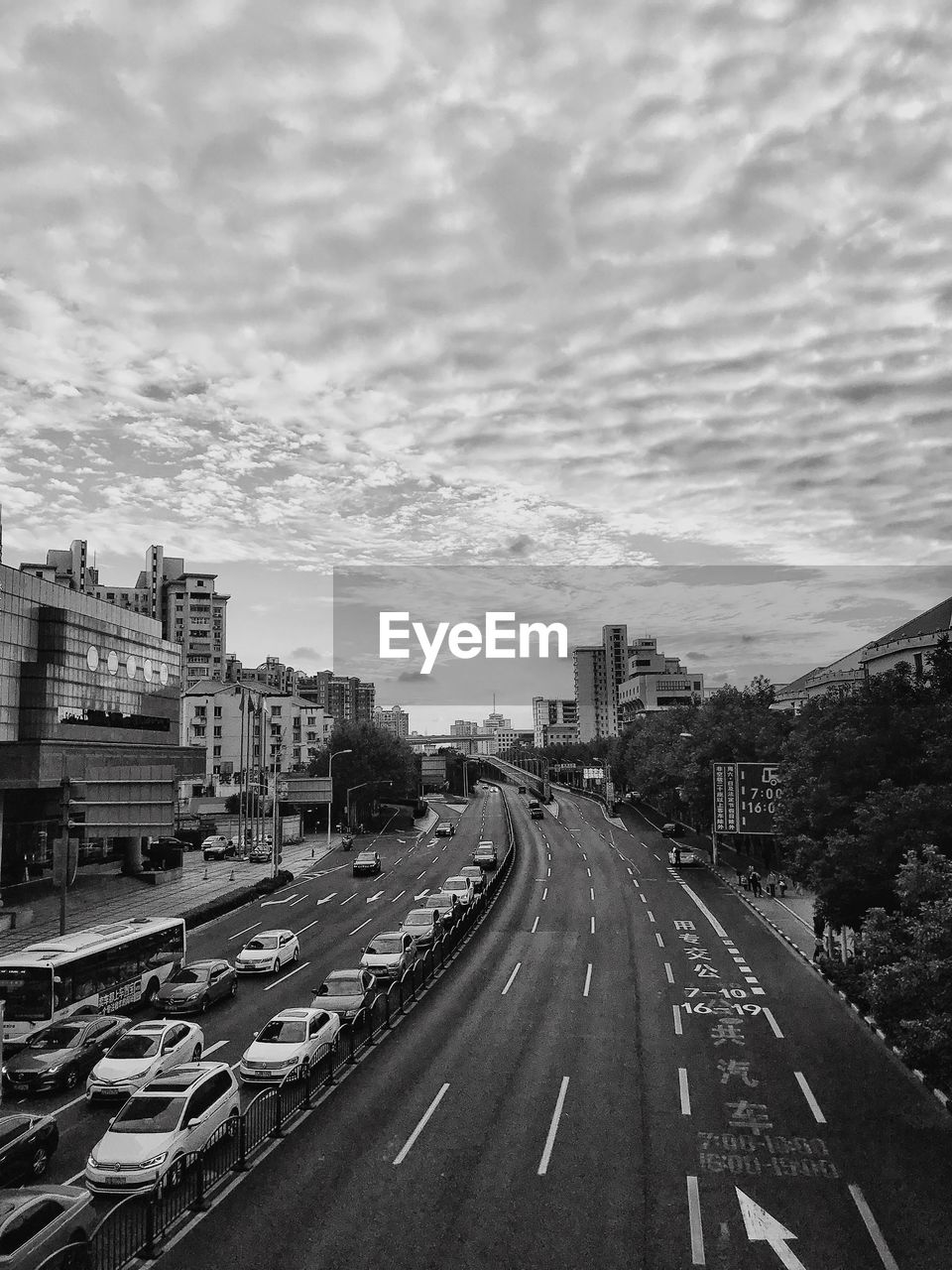 ROAD AMIDST BUILDINGS AGAINST SKY