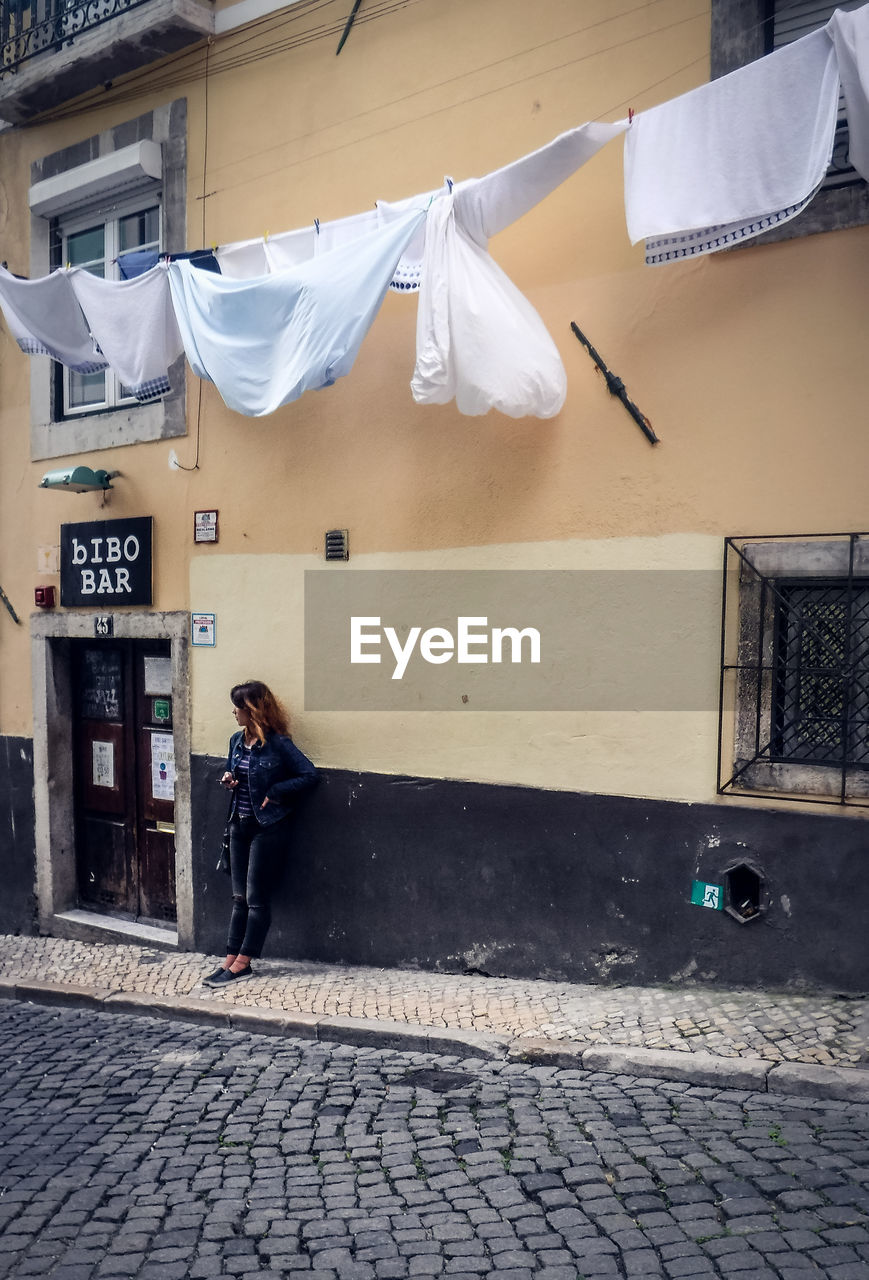 YOUNG WOMAN ON WALL