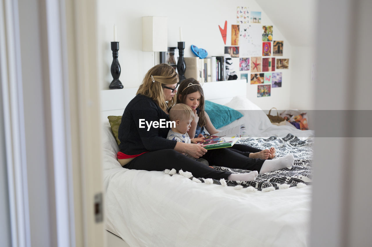 Mother reading with kids