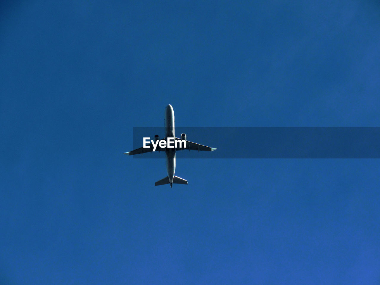 Low angle view of airplane flying in clear sky