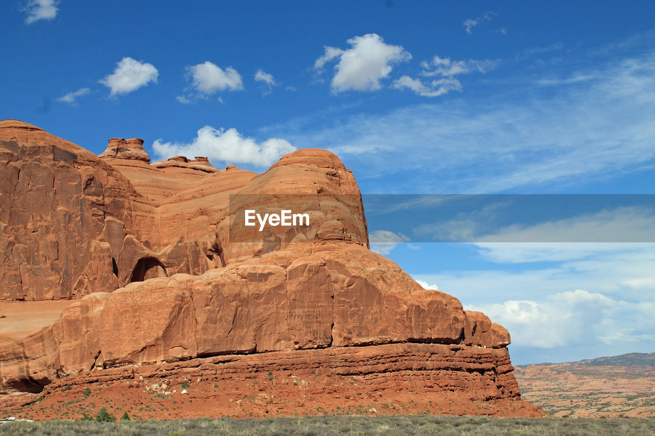 Scenic view of rock formations on landscape against sky