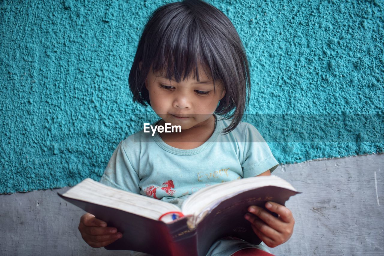 GIRL HOLDING BOOK