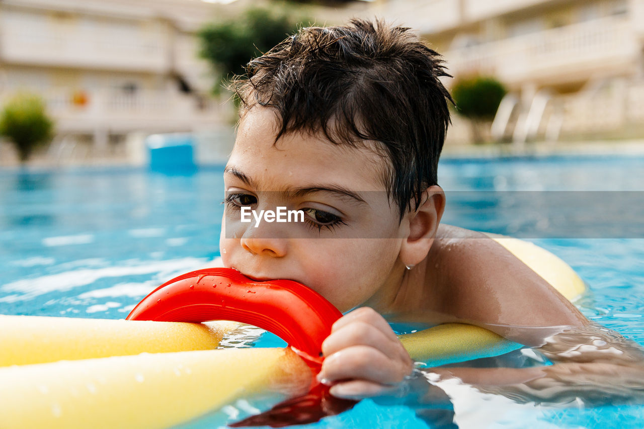 Boy swimming in pool