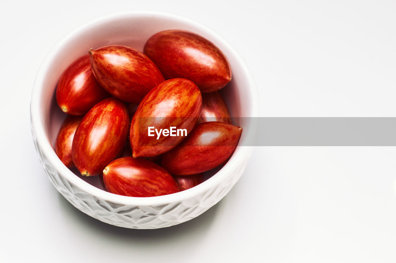 High angle view of nuts in bowl over white background