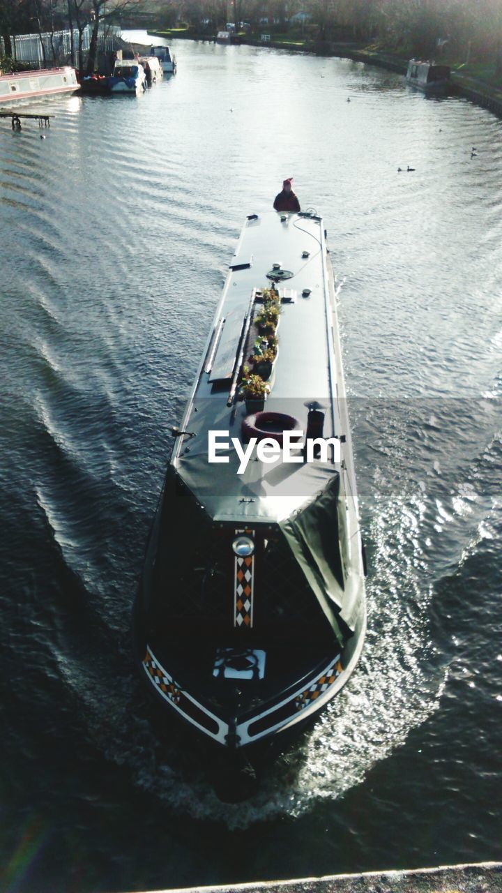 BOATS SAILING IN RIVER