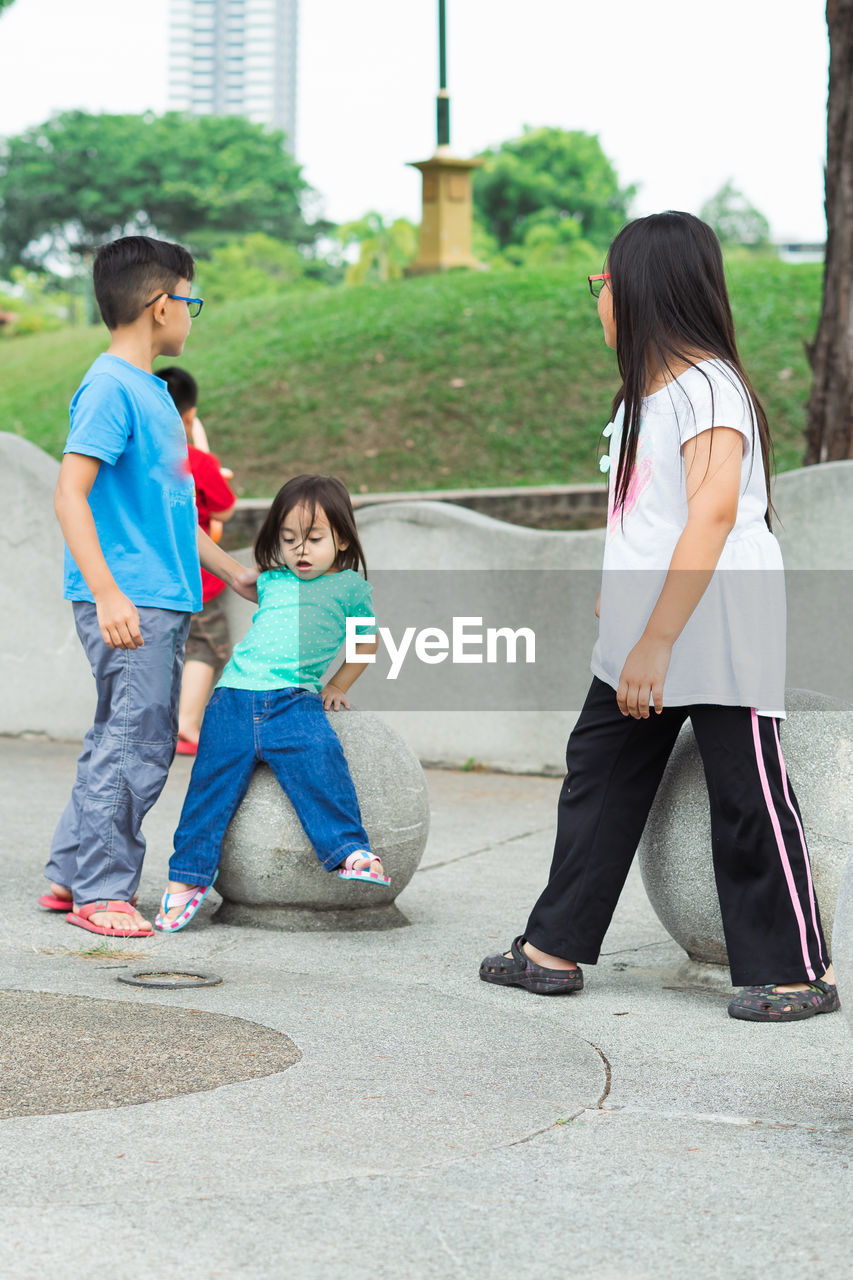 Siblings playing at park