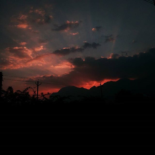 SILHOUETTE OF MOUNTAIN AGAINST CLOUDY SKY