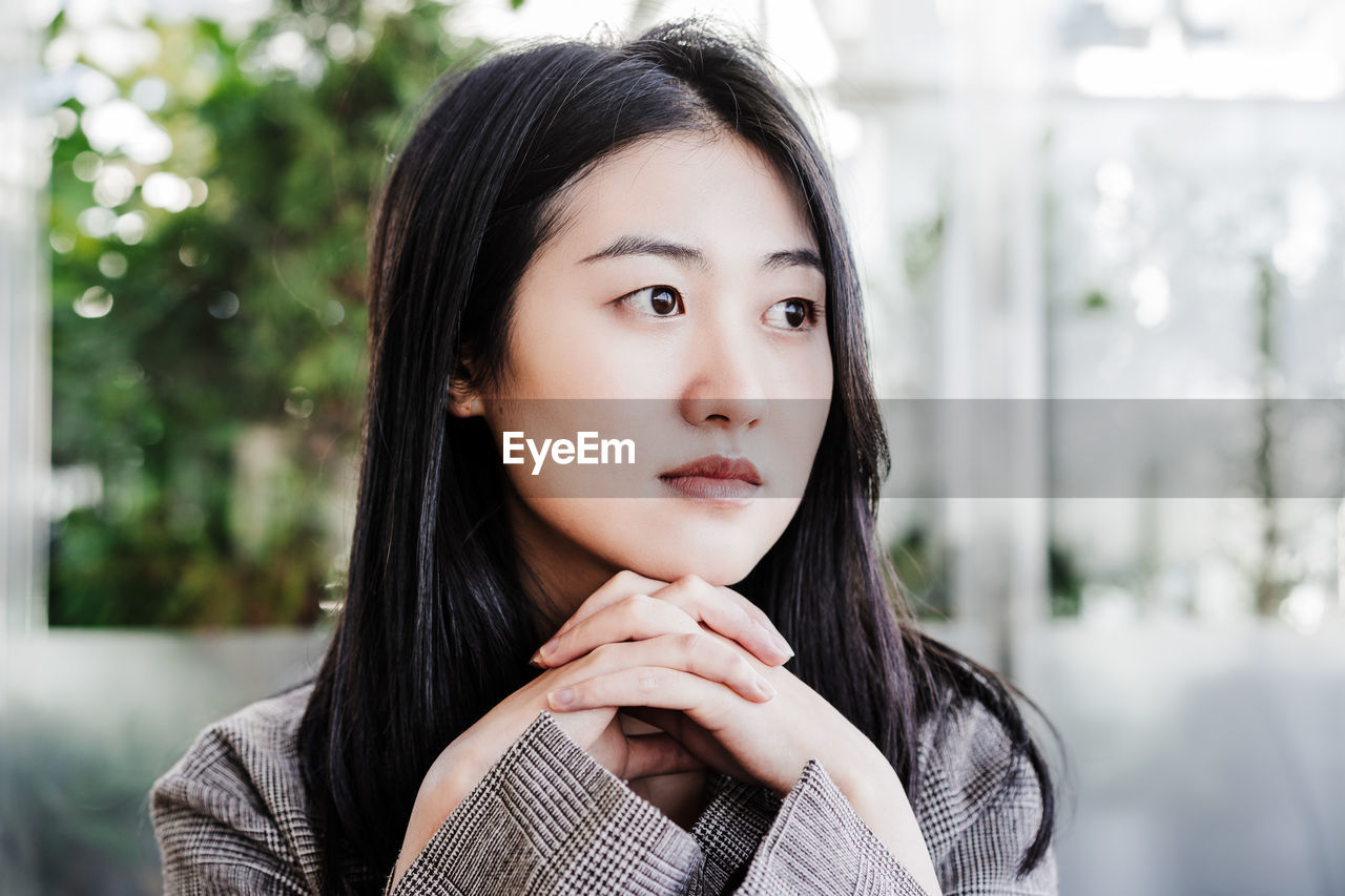 Portrait of confident professional chinese entrepreneur woman in cafeteria. technology, lifestyle