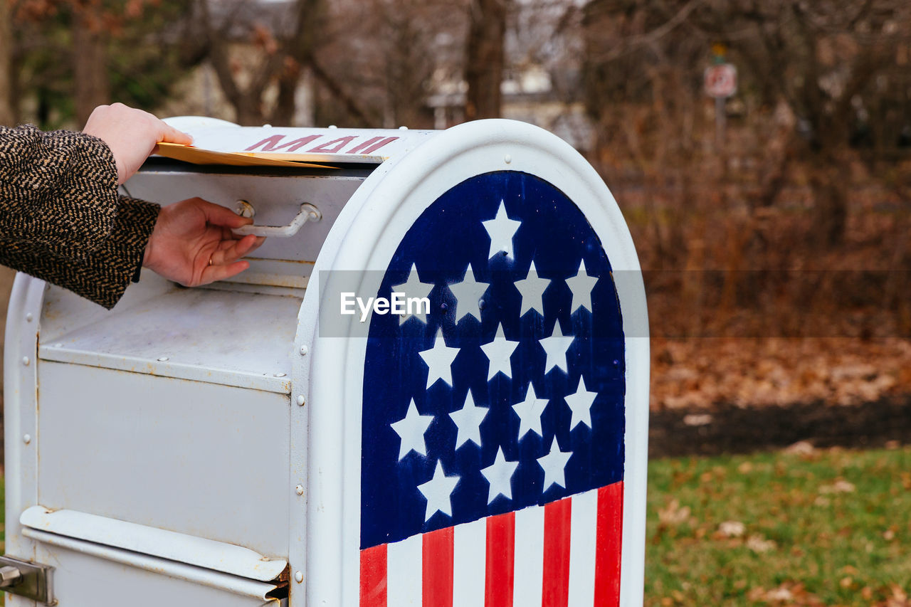 Close-up of hand holding mailbox