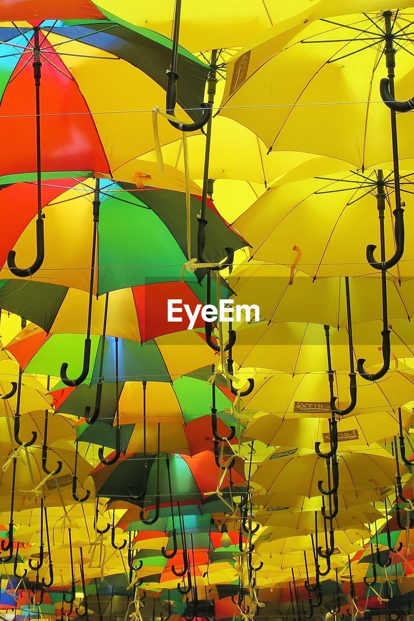 CLOSE-UP OF MULTI COLORED YELLOW UMBRELLA