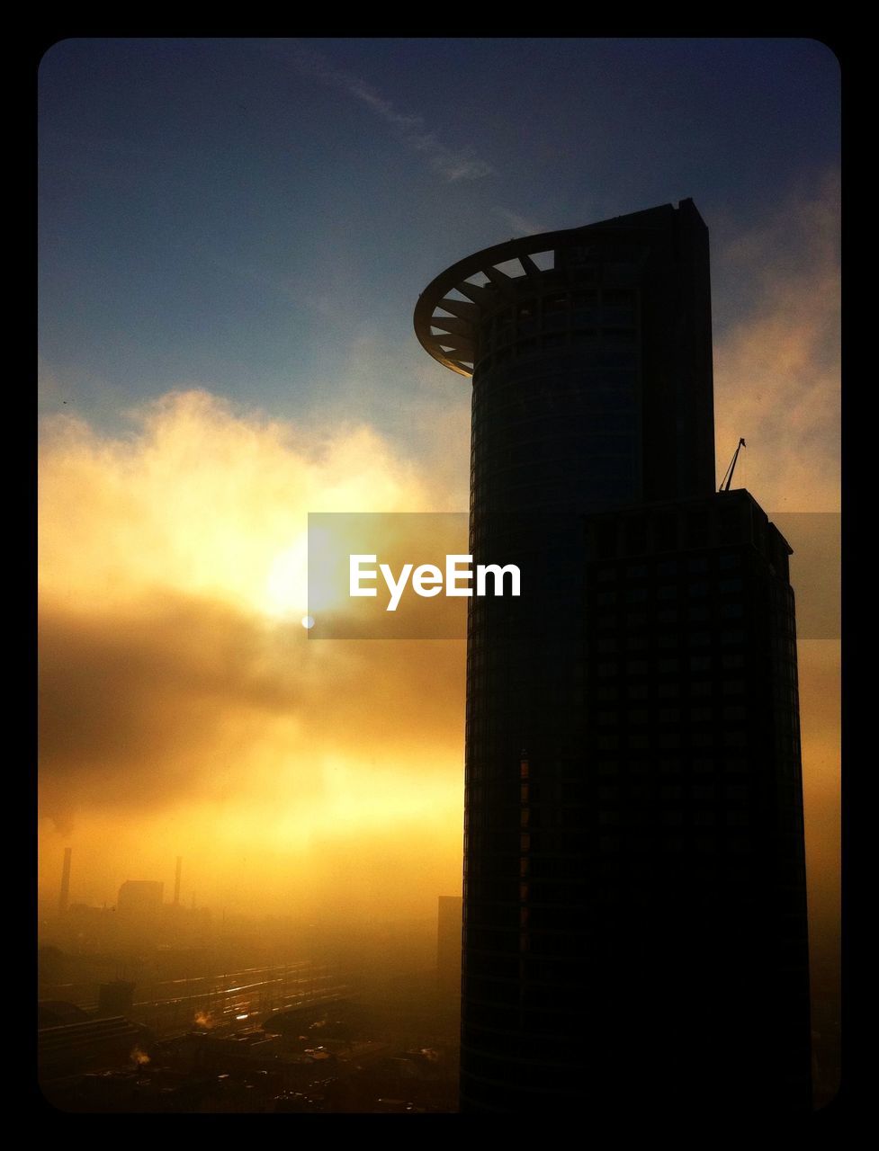 Silhouette of skyscraper at sunset