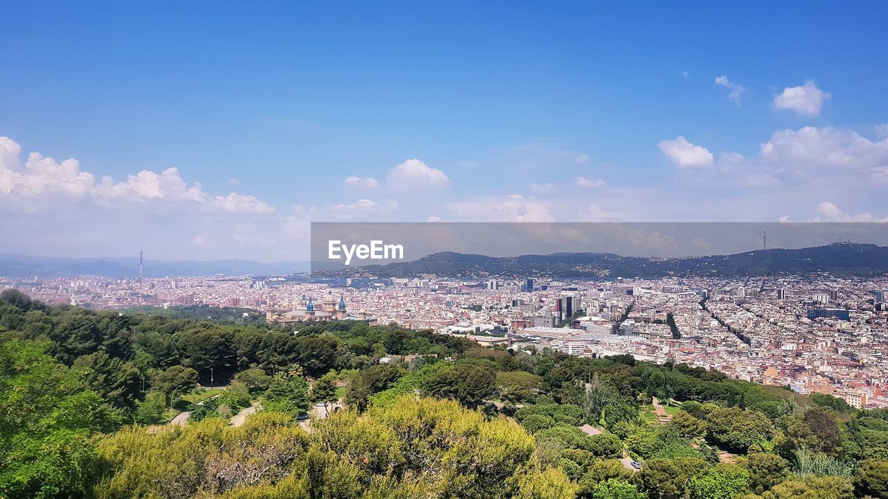 HIGH ANGLE VIEW OF CITY AGAINST SKY