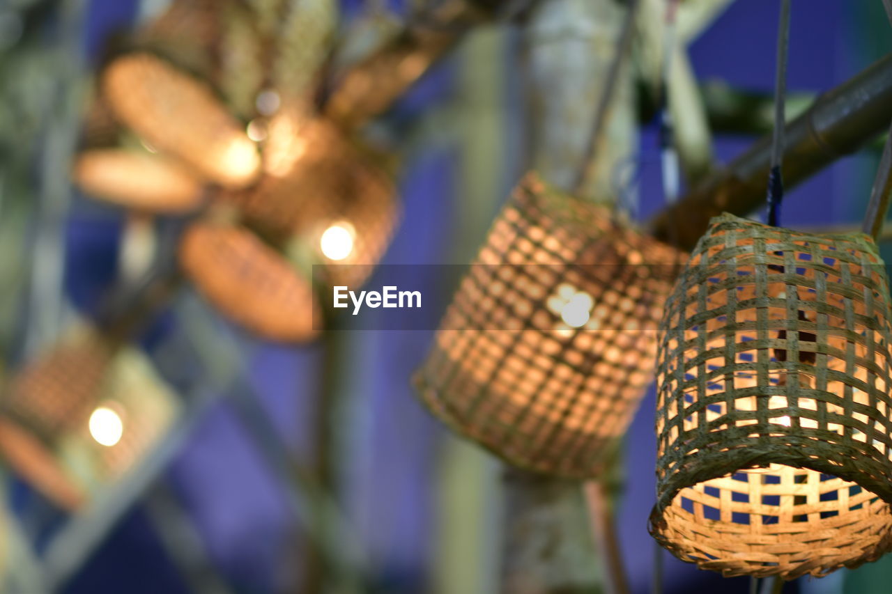 Close-up of illuminated lighting equipment hanging