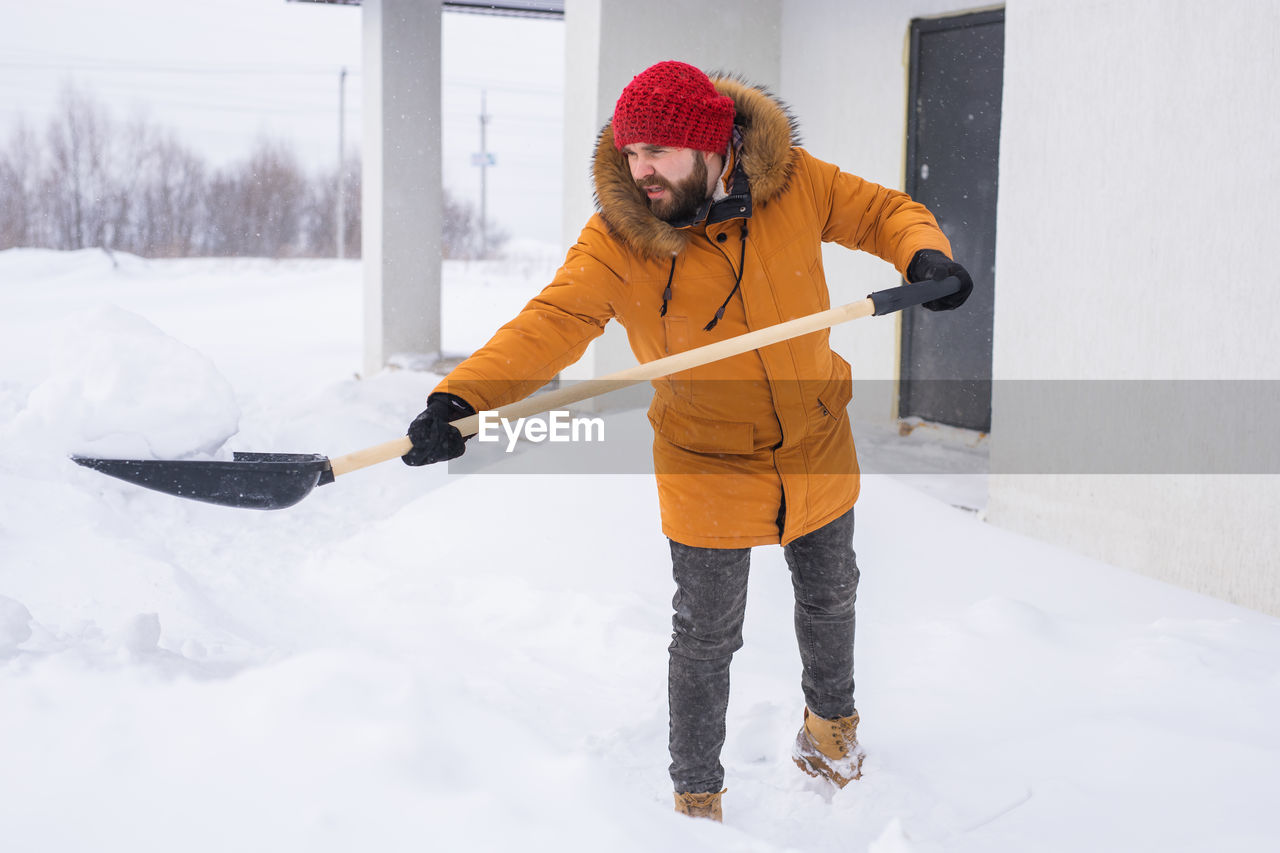 rear view of man standing on snow