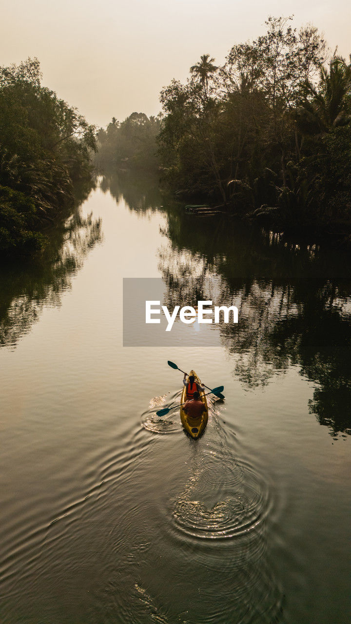 man kayaking in sea
