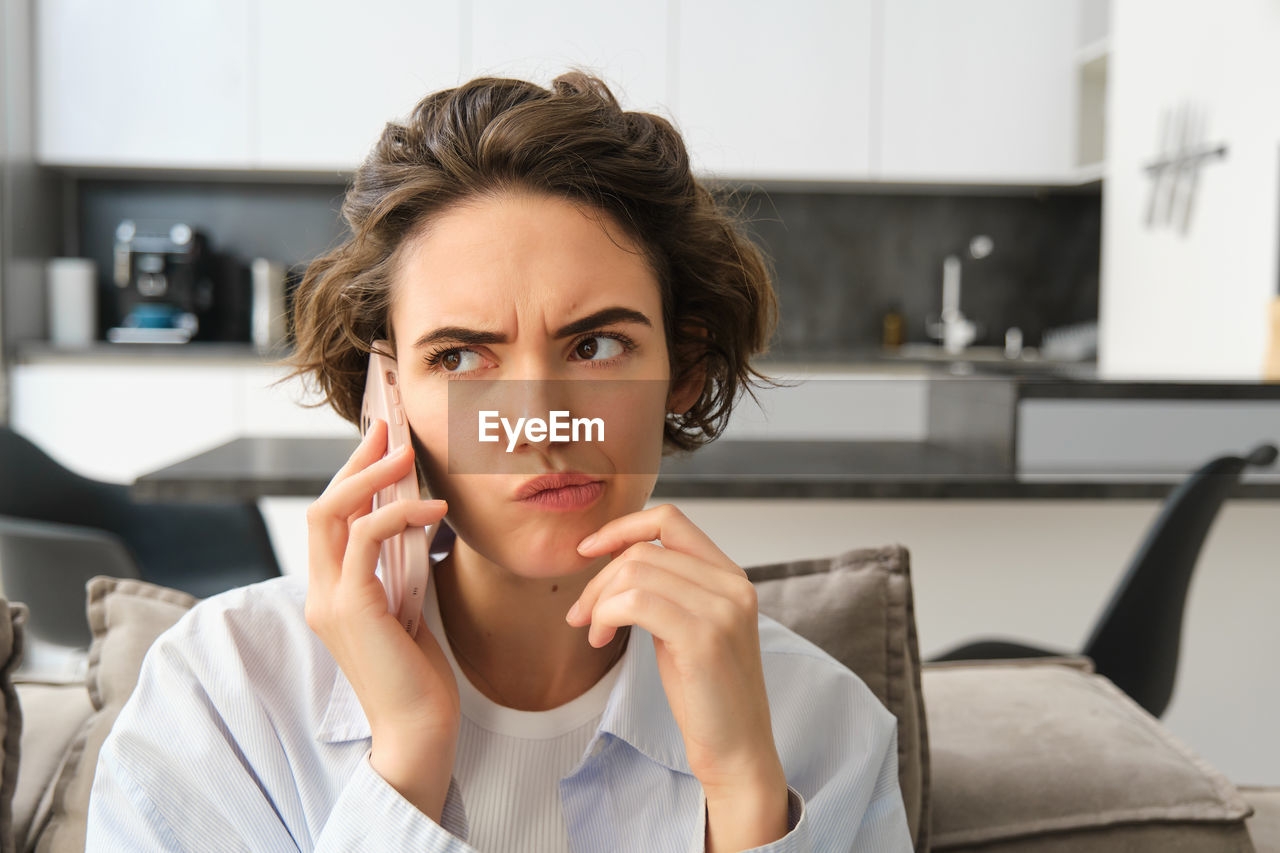 portrait of young woman talking on mobile phone