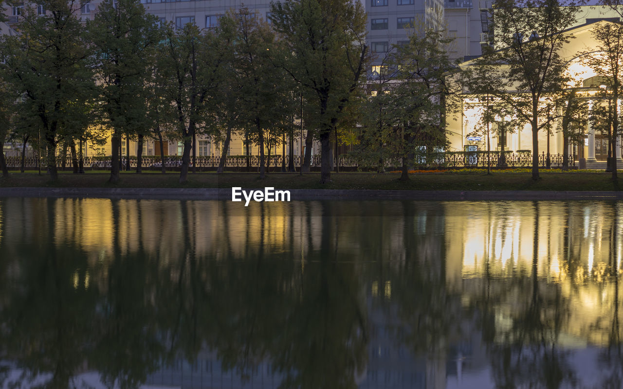 SCENIC VIEW OF LAKE BY TREES IN CITY