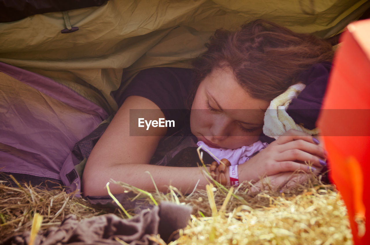 lying down, plant, nature, grass, adult, child, one person, relaxation, childhood, land, straw, women, field, selective focus, agriculture, person, rural scene, casual clothing, food, baby, young adult, food and drink, landscape, emotion, lifestyles, hay, summer, outdoors, brown hair, sleeping, day, female, looking, men, resting