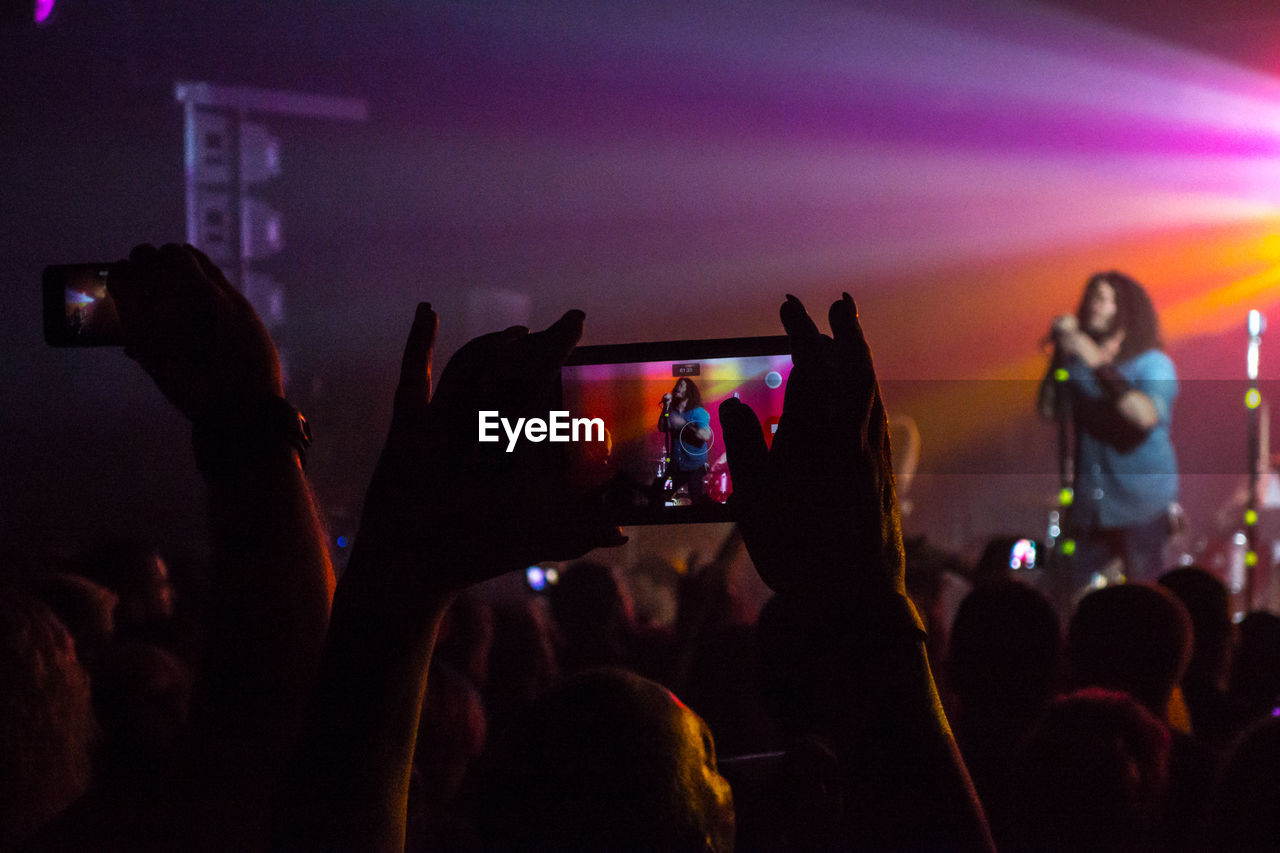 REAR VIEW OF PEOPLE IN NIGHTCLUB