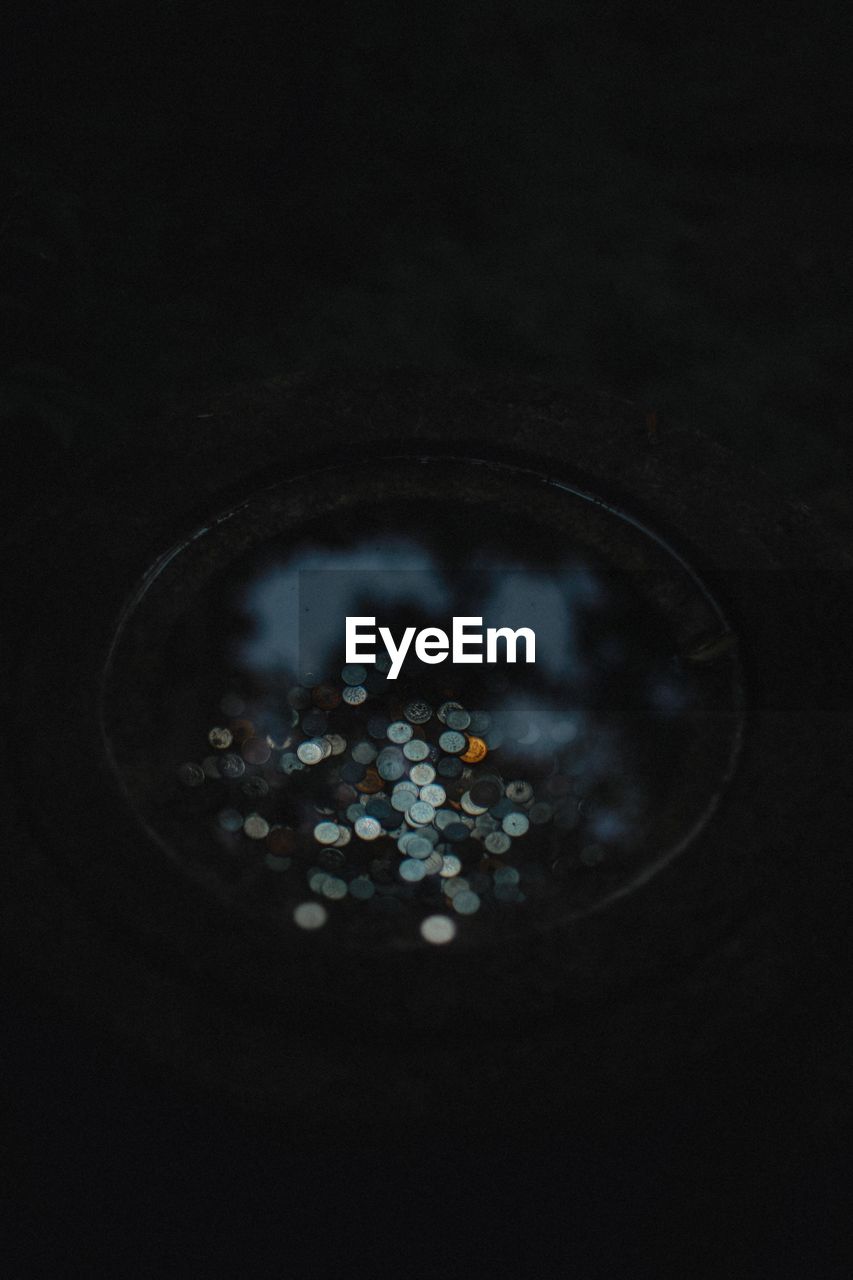 High angle view of coins in pond