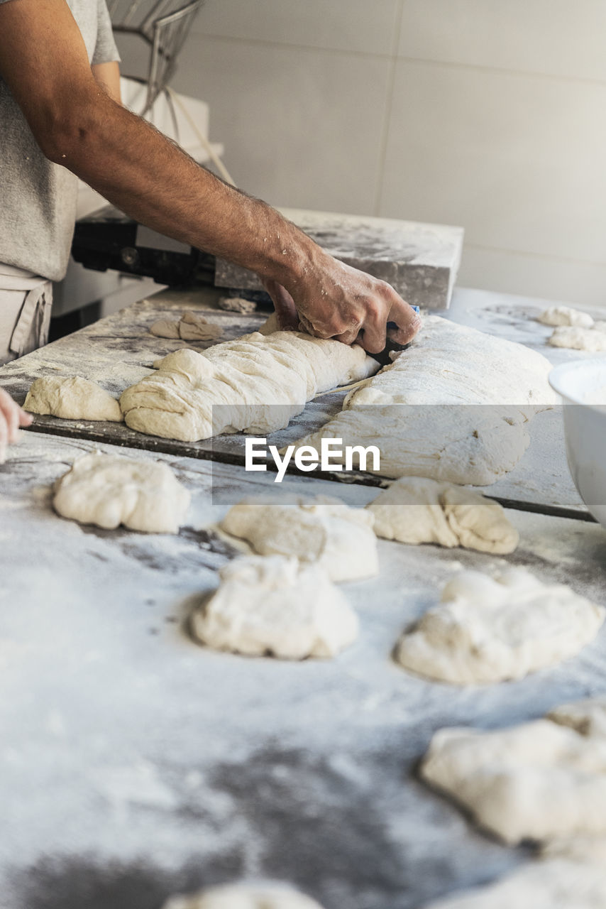 Midsection of male chef preparing food in kitchen