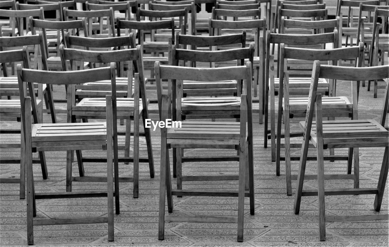 seat, chair, empty, black and white, in a row, no people, absence, monochrome photography, monochrome, arrangement, table, furniture, repetition, large group of objects, day, backgrounds, order, side by side, high angle view, full frame, wood