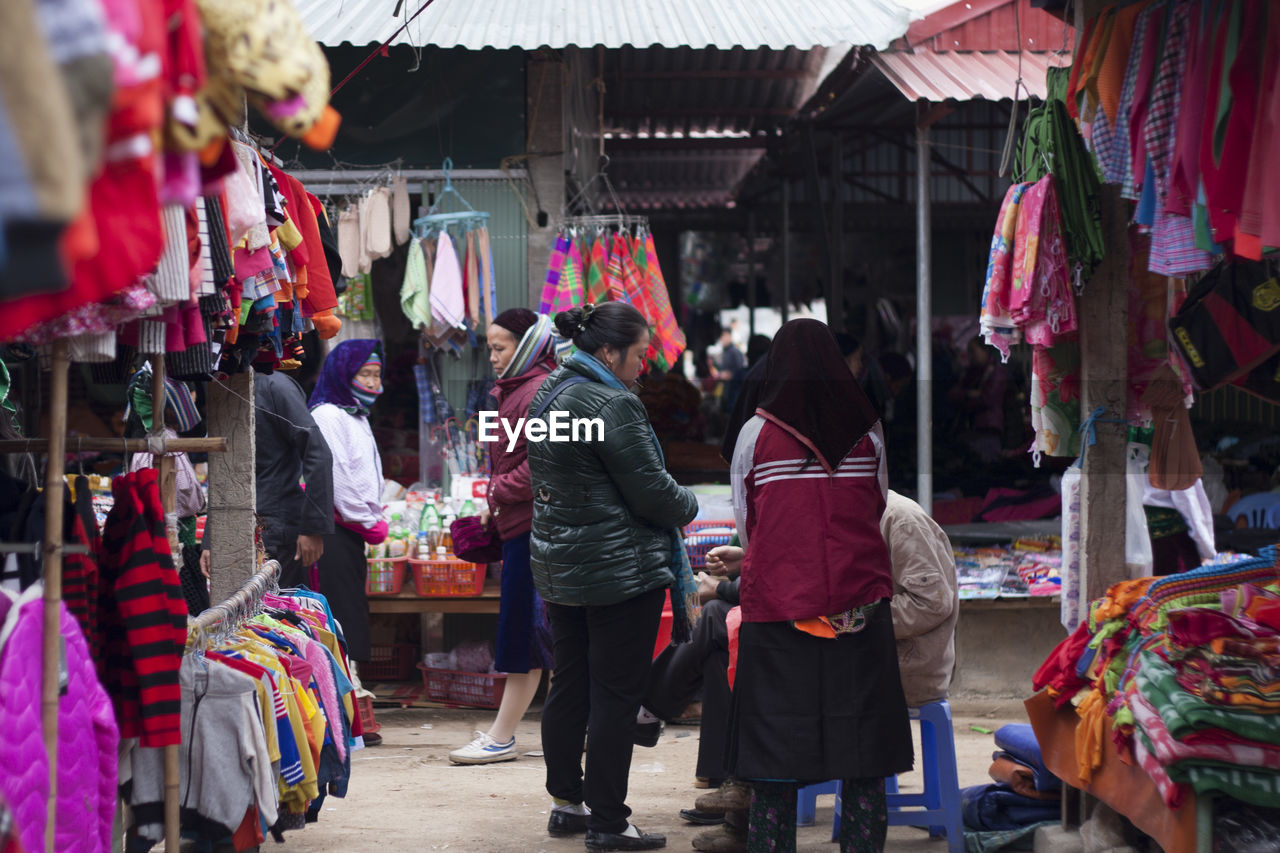 PEOPLE ON DISPLAY AT MARKET STALL