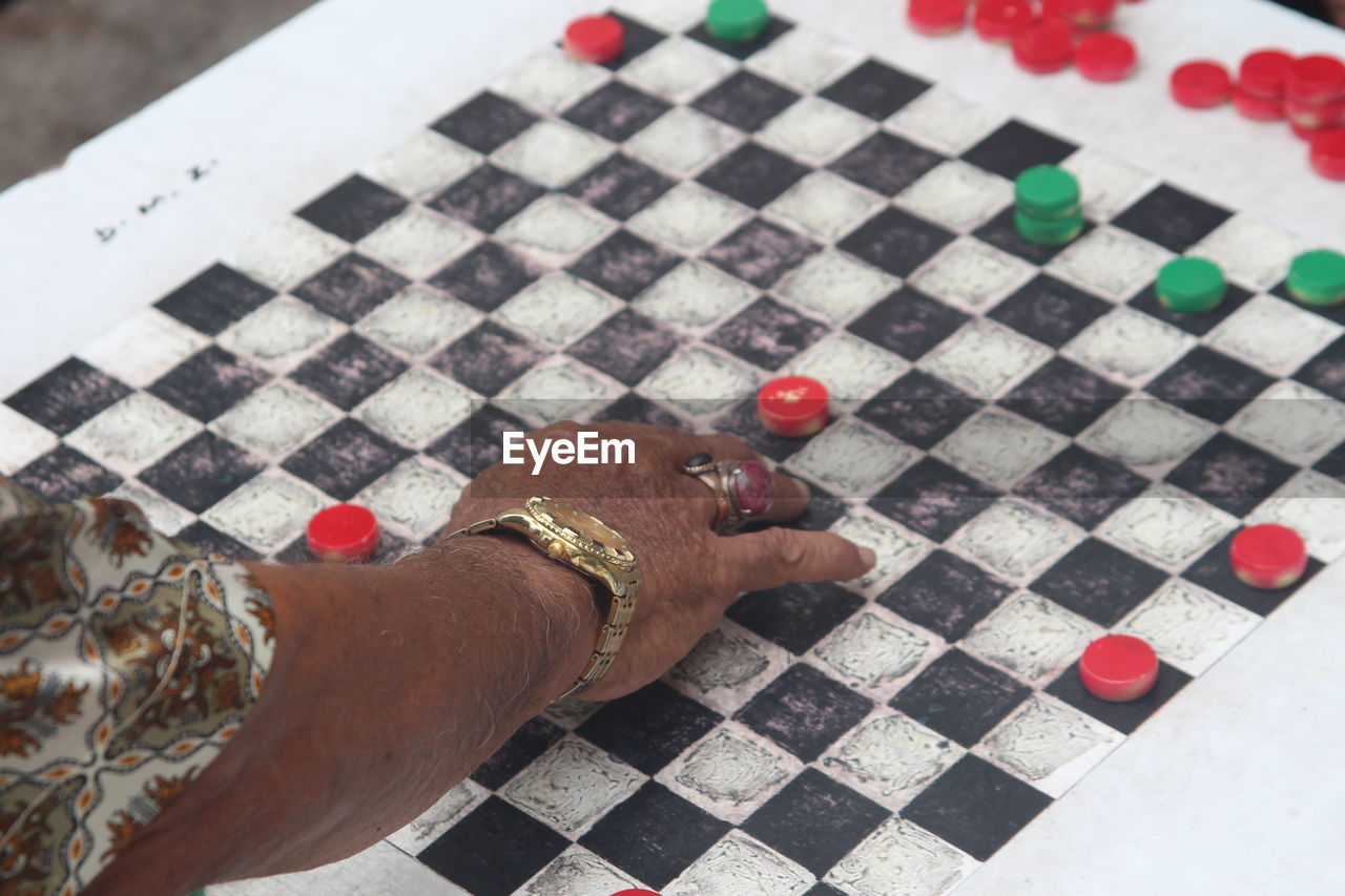 Cropped image of hand playing chess