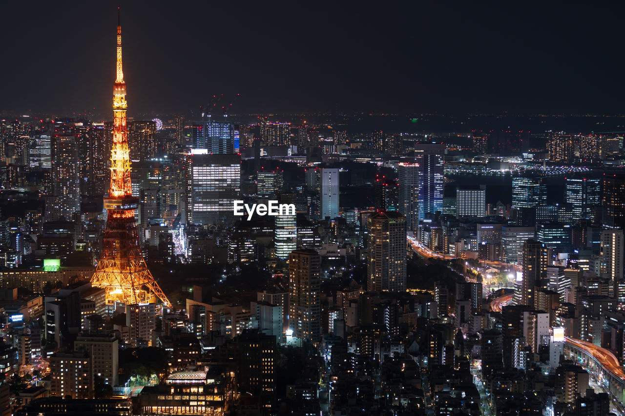 ILLUMINATED CITY AGAINST SKY AT NIGHT