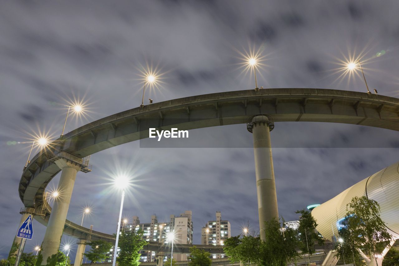 LOW ANGLE VIEW OF ILLUMINATED FERRIS WHEEL AGAINST SKY