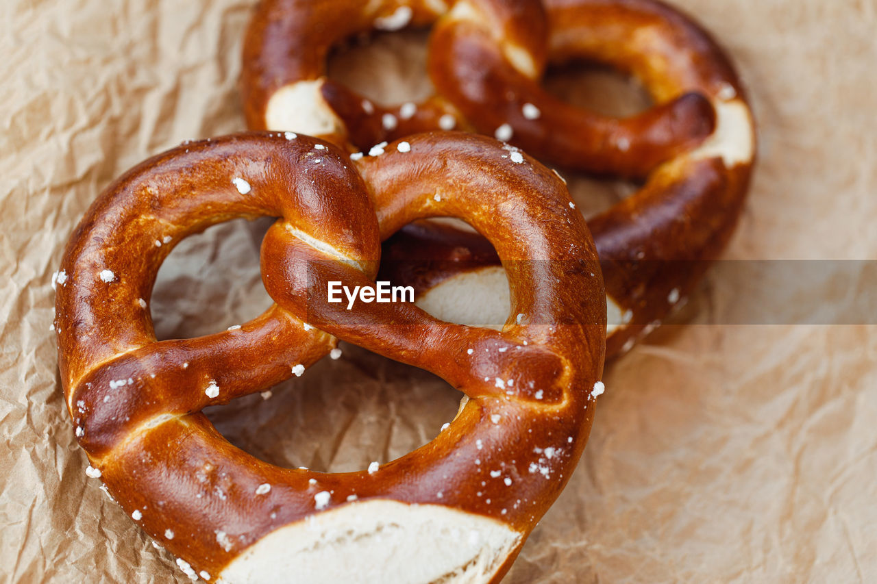 Two traditional soft octoberfest pretzels on brown paper