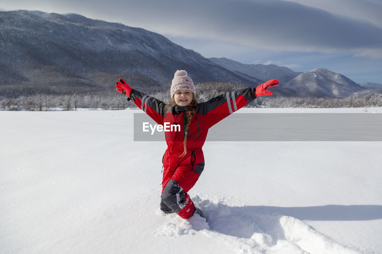 Young girl is having winter fun on a snowy, sunny day in lika, croatia