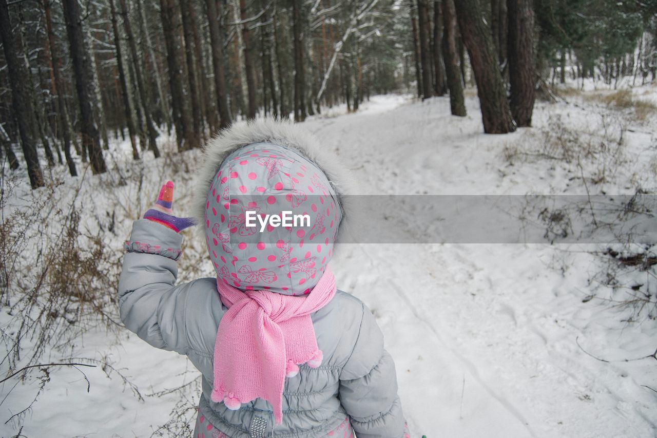 Child in snow covered forest