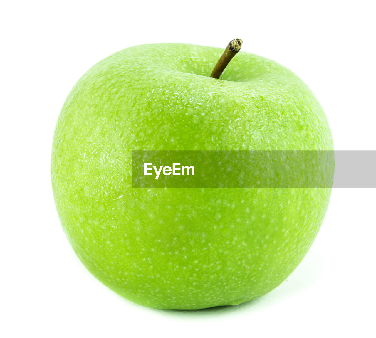 Close-up of green apple over white background