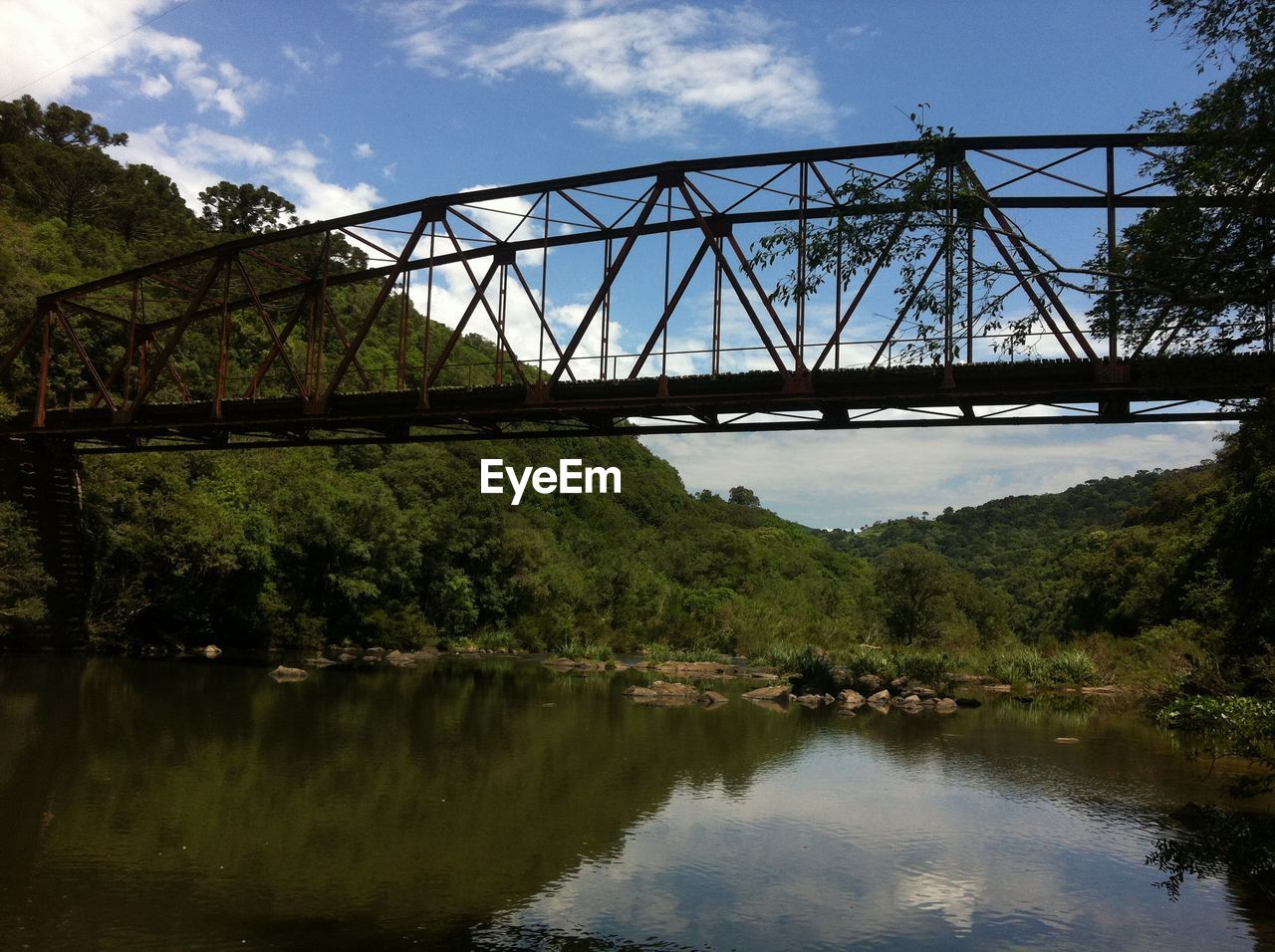 Low angle view of bridge over lake against sky