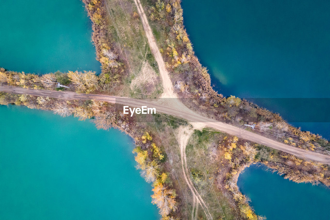 High angle view of lakes decided by road and trees
