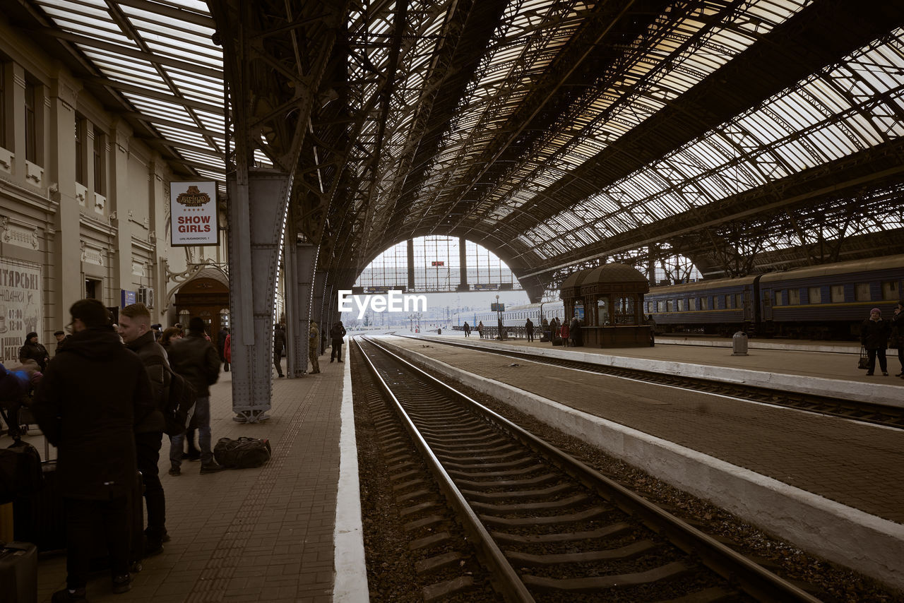 PEOPLE AT RAILROAD STATION PLATFORM