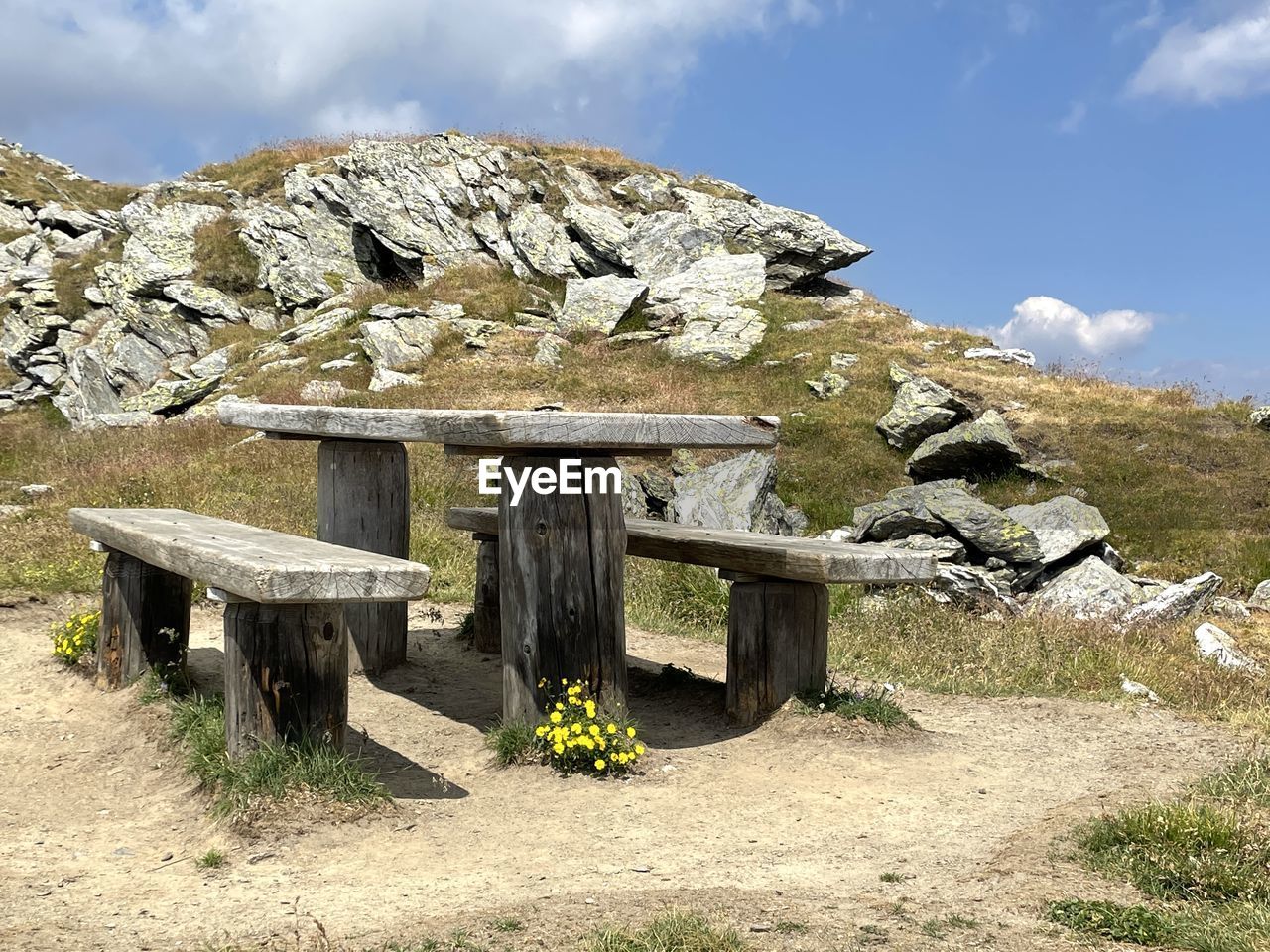 Scenic view of mountains and a bench to rest 