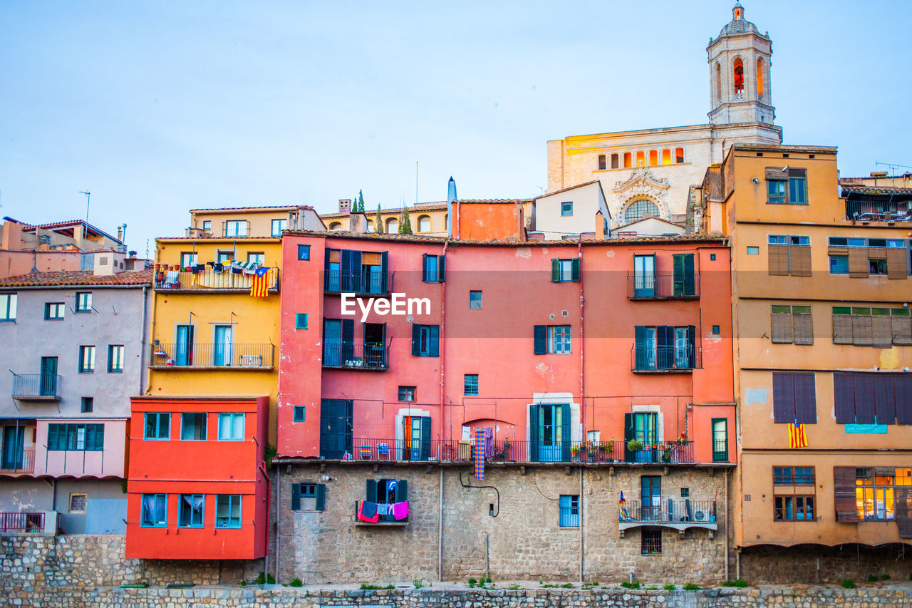 Multi colored residential buildings against sky