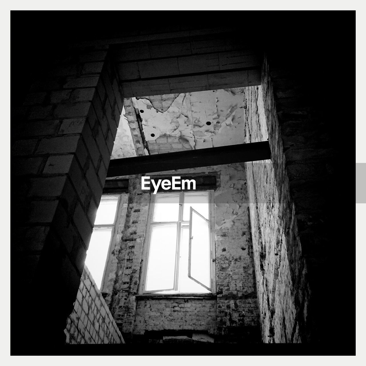 Low angle view of window in abandoned house