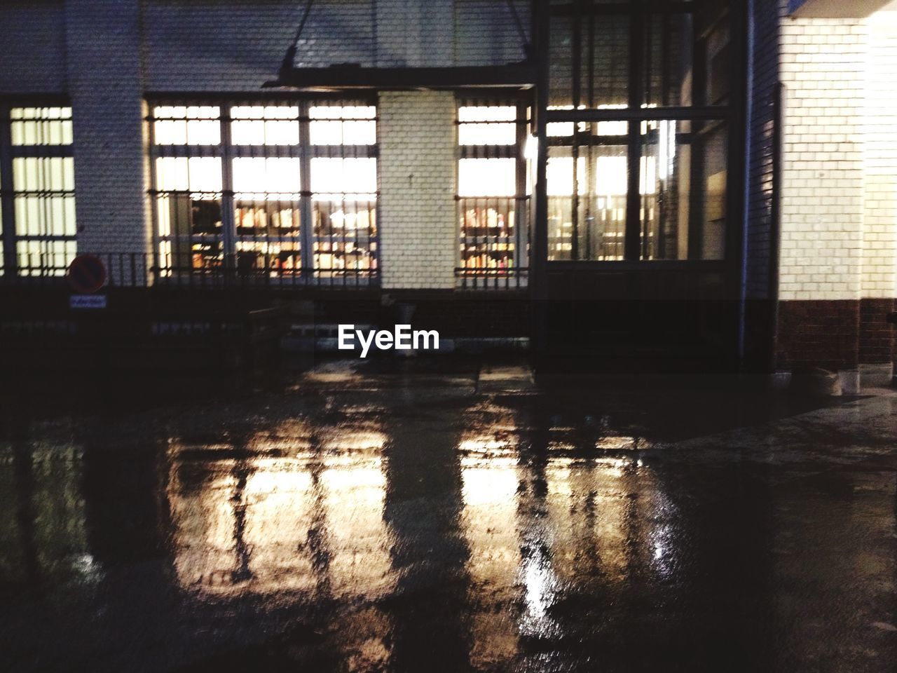 Wet street in front of building