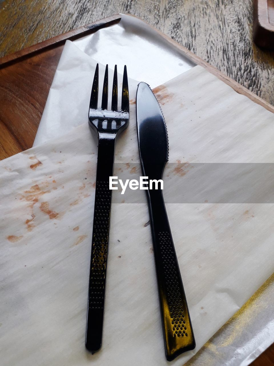 HIGH ANGLE VIEW OF FORK AND KNIFE ON TABLE