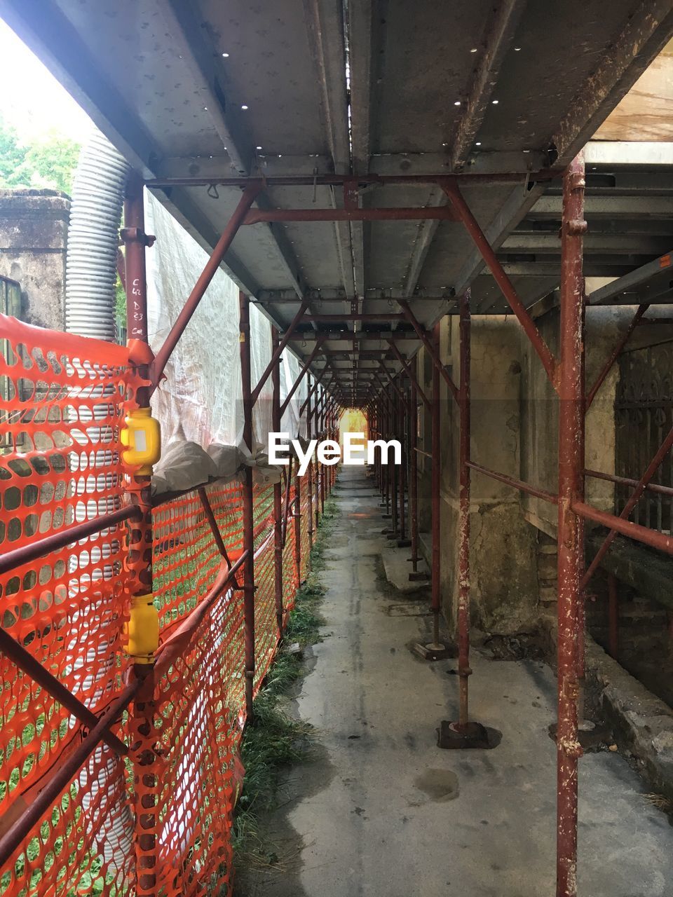 Empty corridor under scaffolding at construction site