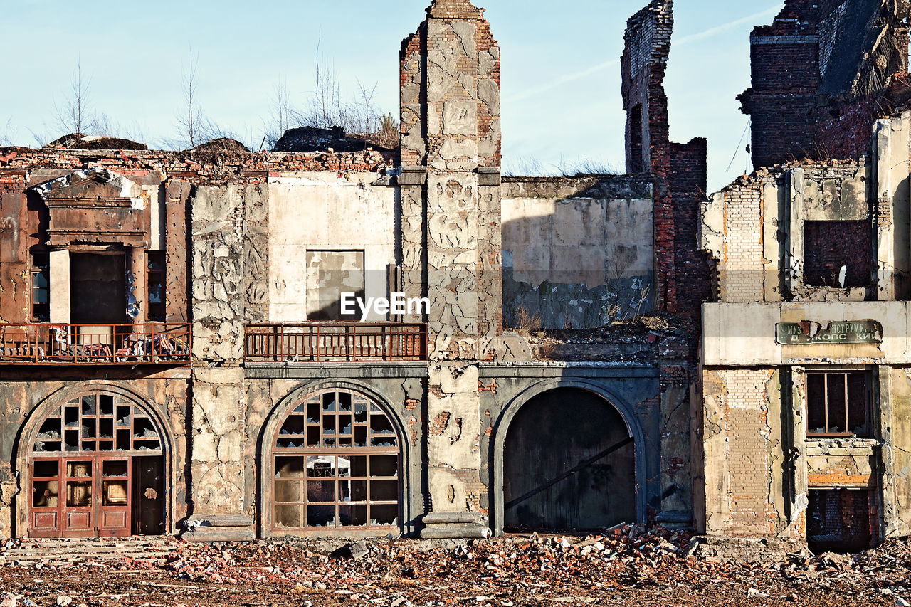 Landscape of ruined buildings at sunset, image of decrepitude or natural disaster