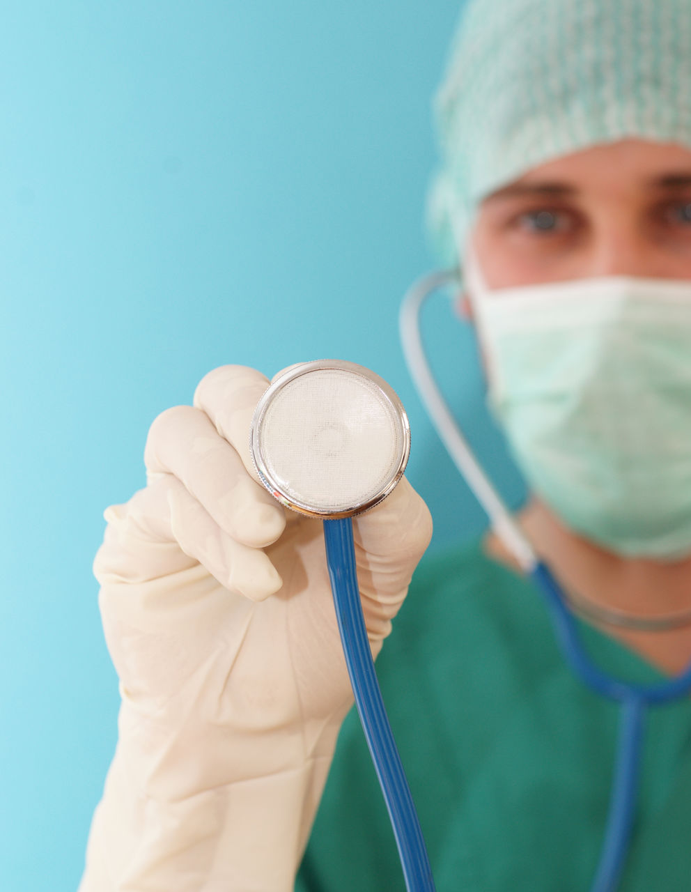 Young doctor surgeon orthopedist with breathing mask and hood after surgery